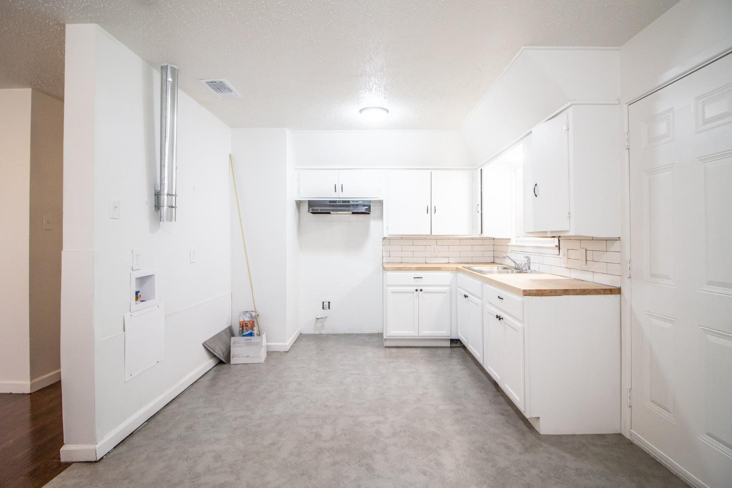 5105 39th Street Lubbock, TX 79414 - Photo 7 of 18 a view of a kitchen with white cabinets