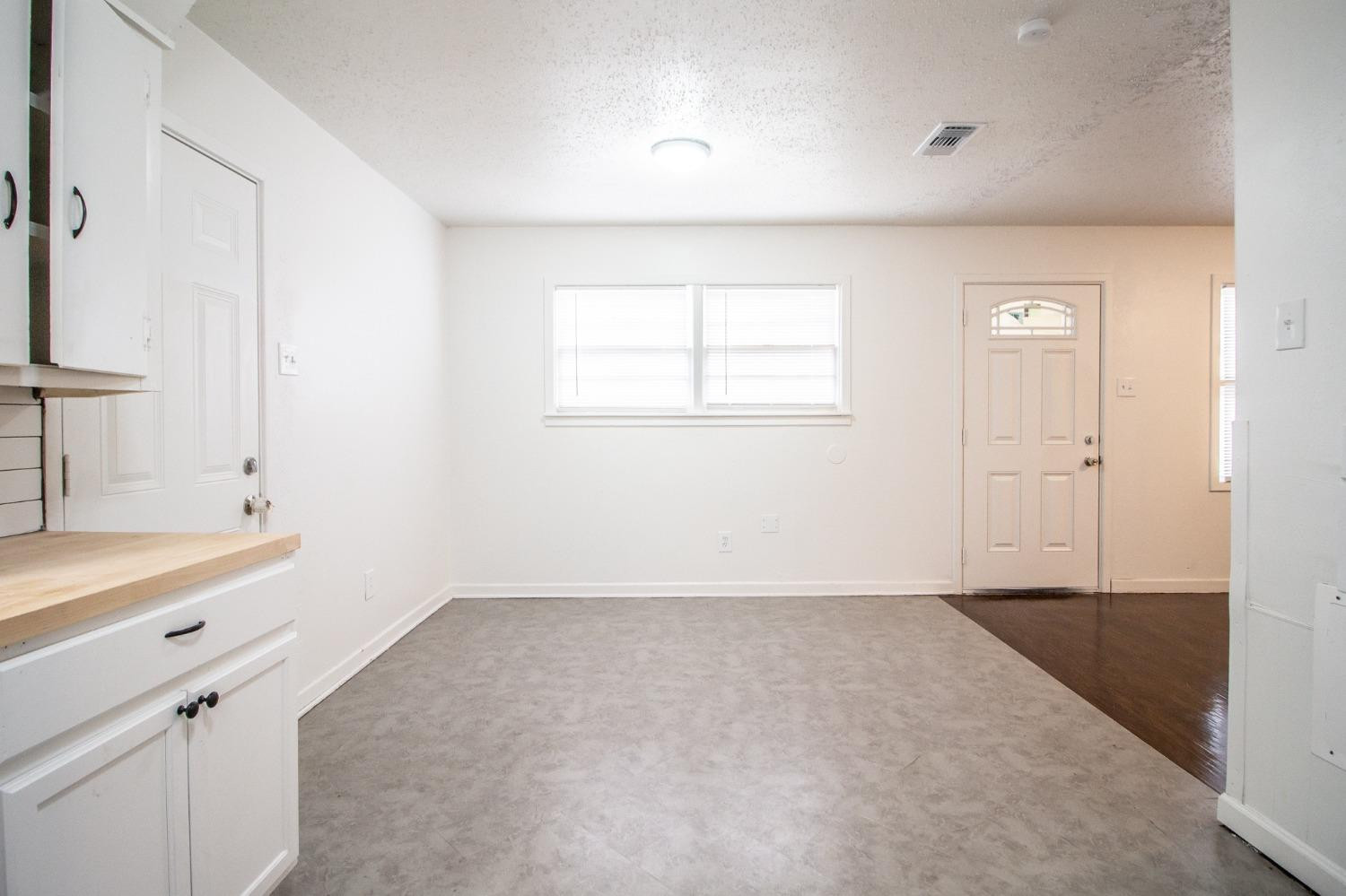 5105 39th Street Lubbock, TX 79414 - Photo 10 of 18 wooden floor in an empty room with a window