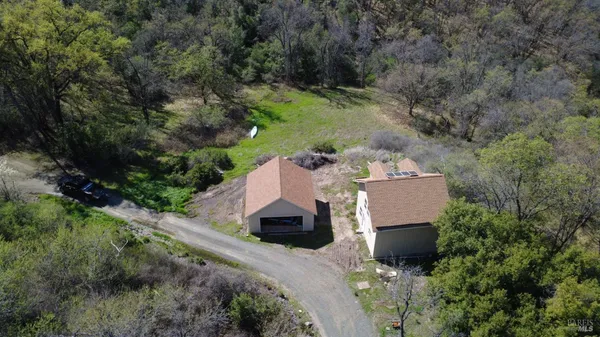 an aerial view of a house with a yard