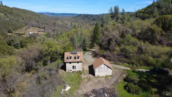 an aerial view of a house with a yard