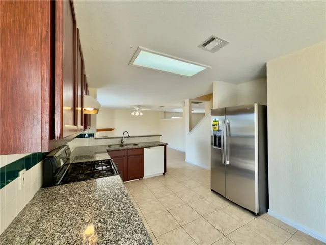 a kitchen with a refrigerator and a sink