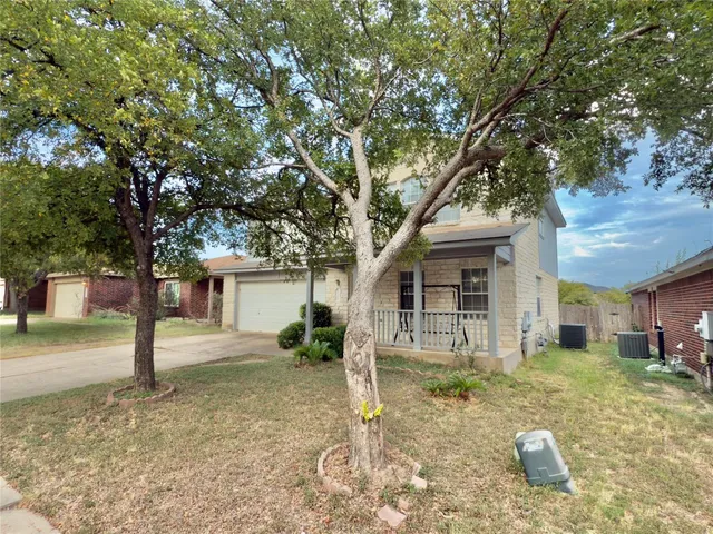a house that has a tree in front of it