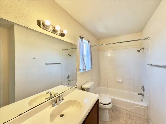 a bathroom with a sink mirror toilet and bathtub