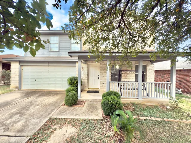 a view of a house with a yard and table and chair