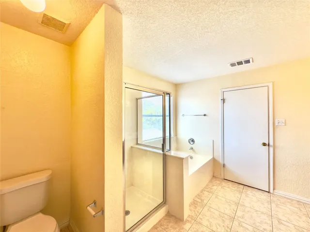 a bathroom with a tub and shower