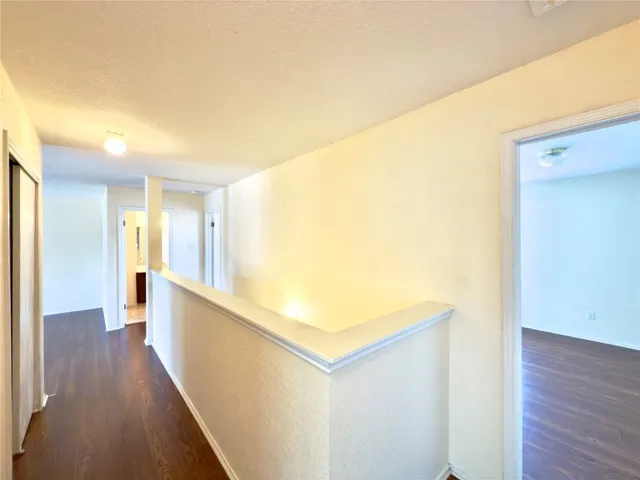 a view of hallway with wooden floor