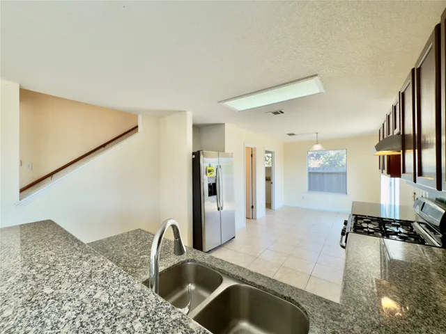 a kitchen with a faucet a sink and a refrigerator