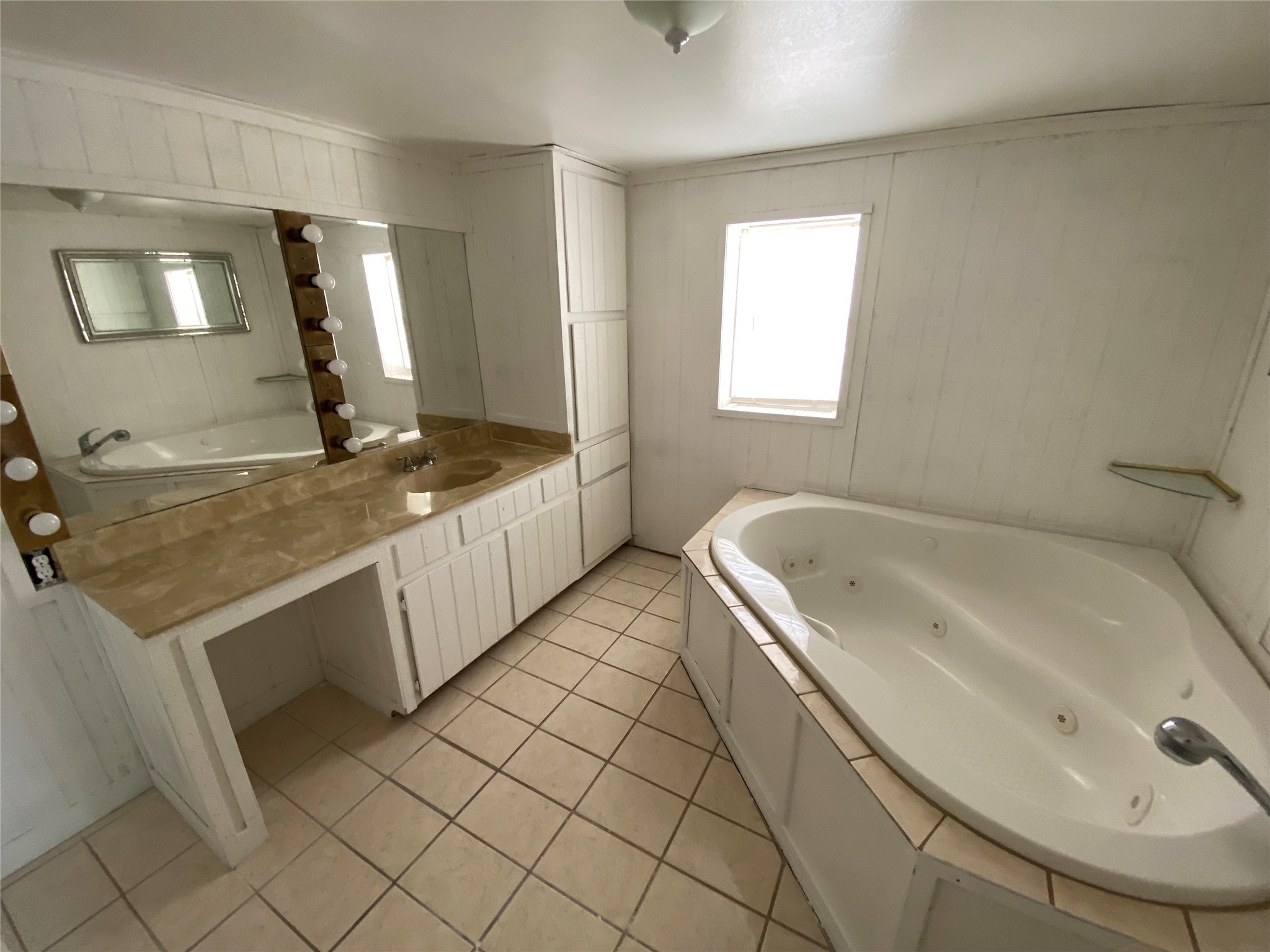 20672 Trinity Way New Caney, TX 77357 - Photo 28 of 41 a spacious bathroom with a granite countertop sink and a bathtub