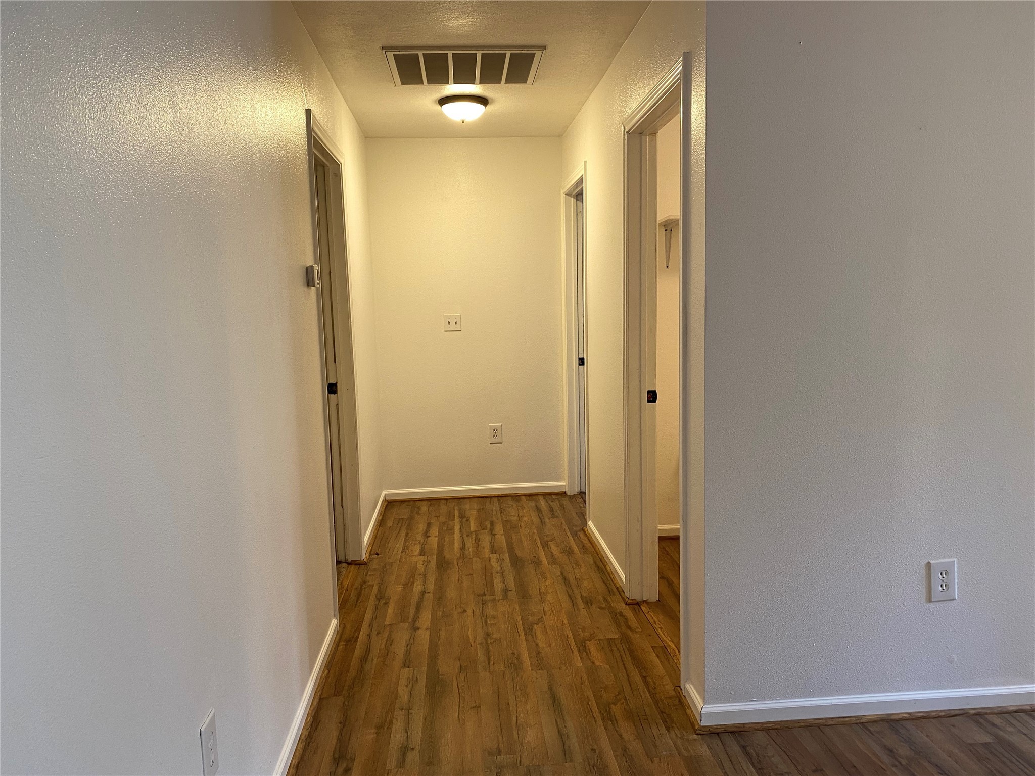 20672 Trinity Way New Caney, TX 77357 - Photo 7 of 41 a view of a hallway with wooden floor