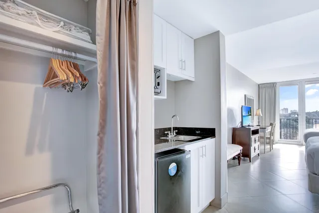 a kitchen view with a stove a refrigerator and a view of living room