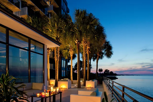 a bedroom with furniture and large windows