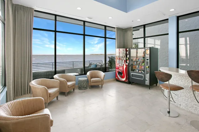 a living room with furniture and large windows