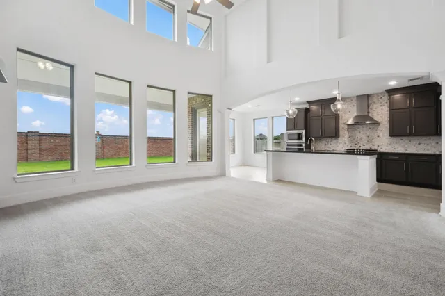 a view of empty room with fireplace and stairs