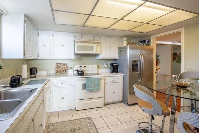 a kitchen with a sink appliances and cabinets
