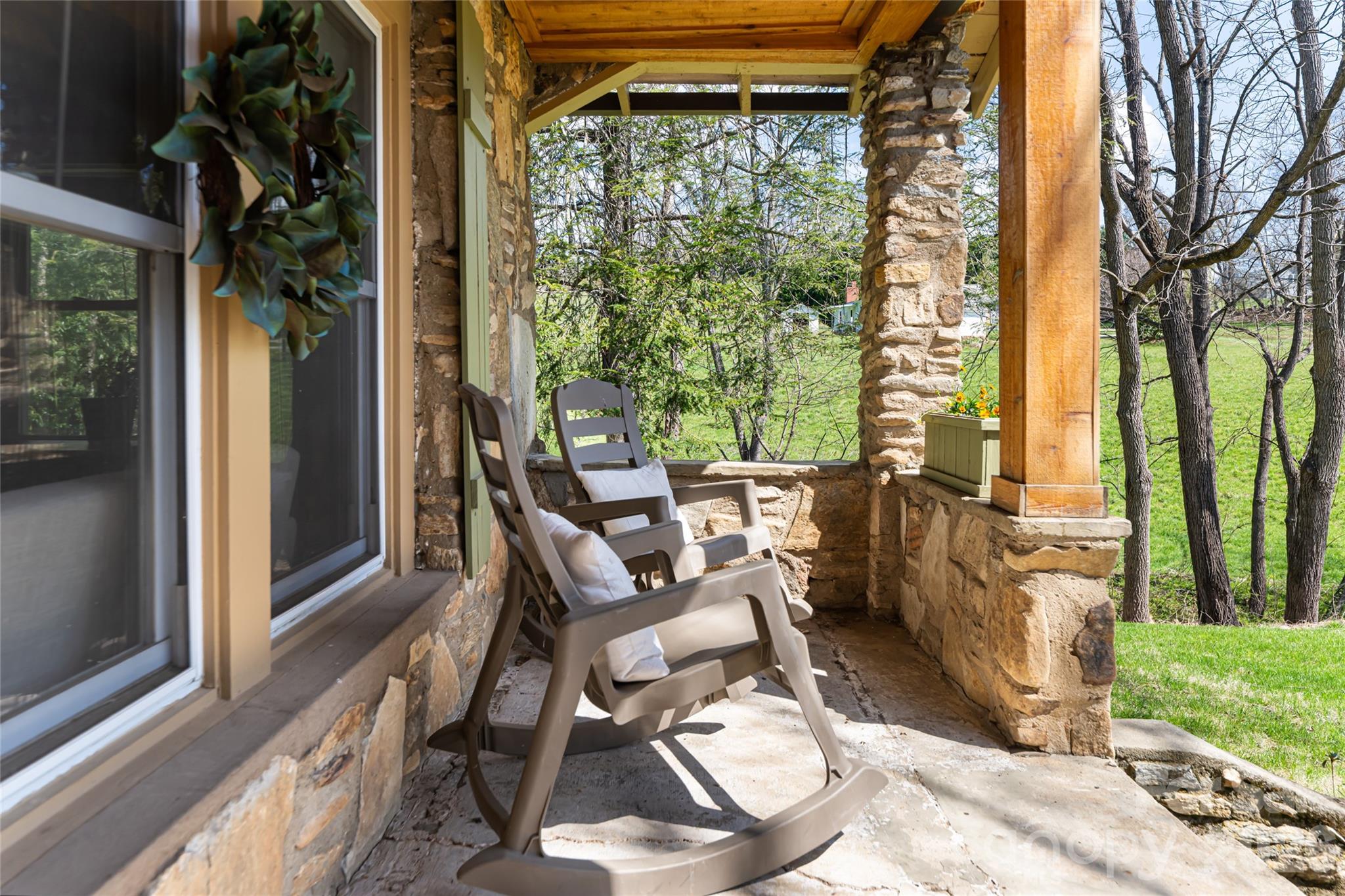 86 Rolling Hills Road Canton, NC 28716 - Photo 46 of 48 a view of a patio with table and chairs and floor to ceiling window