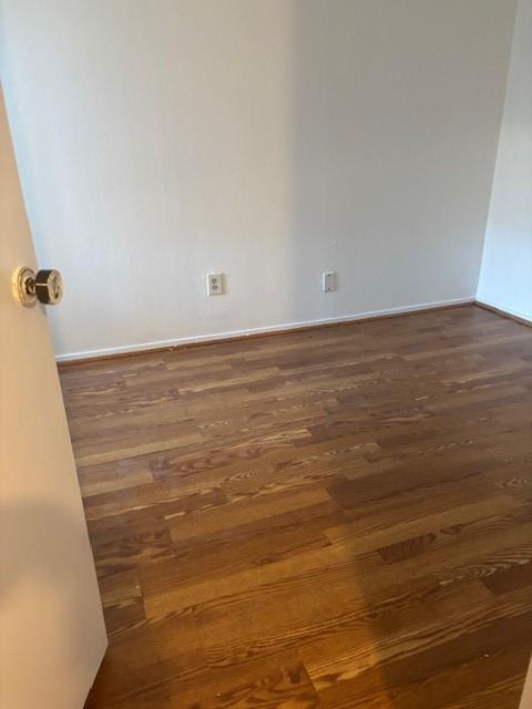 11311 Audelia Road, Unit 208 Dallas, TX 75243 - Photo 3 of 11 Spare room with dark wood-type flooring and baseboards