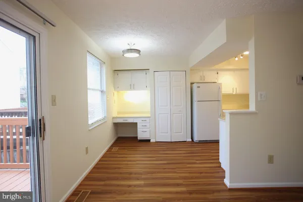 a kitchen with a sink a refrigerator a stove and white cabinets