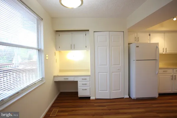 a kitchen with cabinets appliances a sink and a window