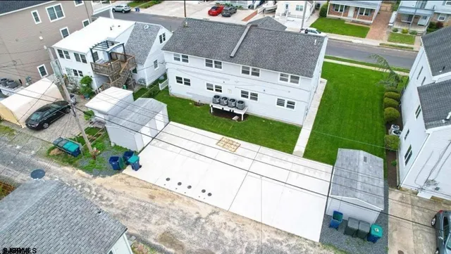 an aerial view of a house with a yard and garden