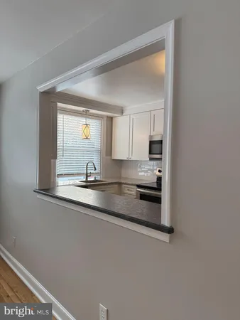 a stove top oven sitting inside of a kitchen