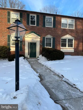 a view of a room with wooden floor and a bathroom