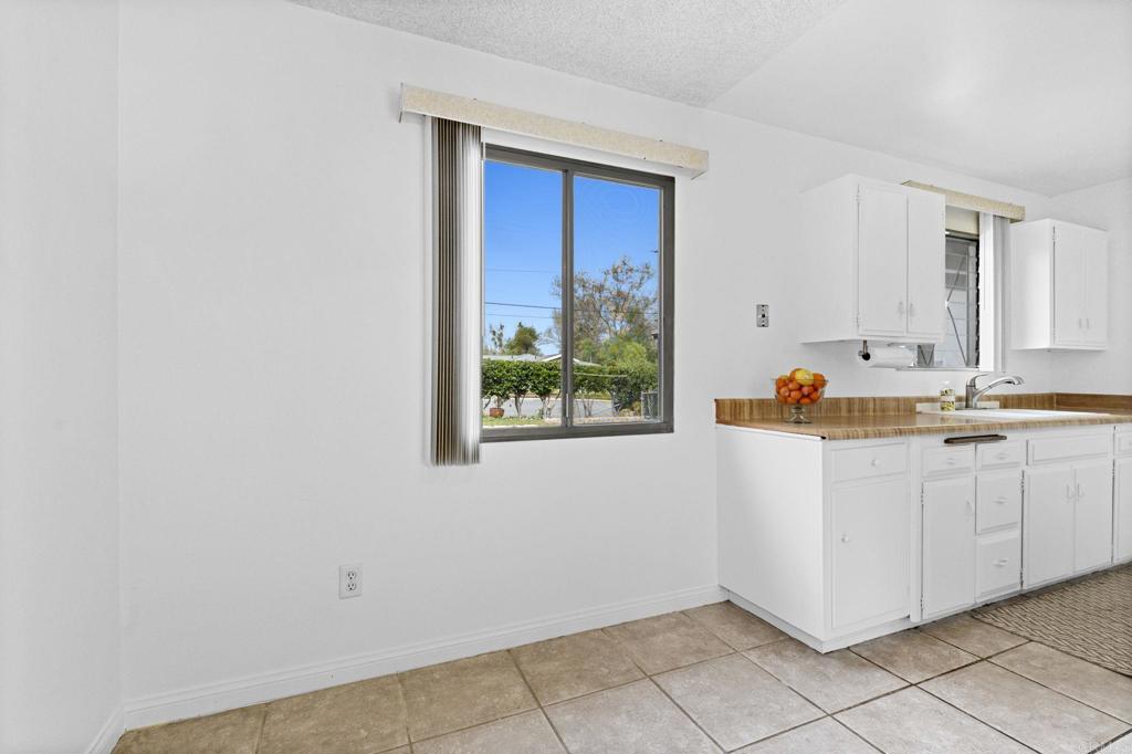8109 Arlette Street Santee, CA 92071 - Photo 11 of 29 a view of kitchen with wooden floor and window