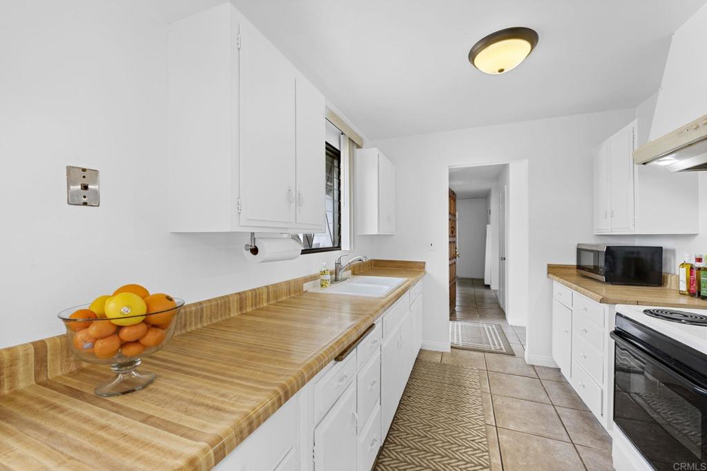 8109 Arlette Street Santee, CA 92071 - Photo 12 of 29 a large kitchen with a sink and a stove top oven