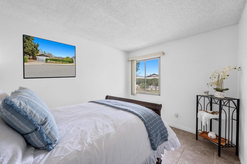 8109 Arlette Street Santee, CA 92071 - Photo 17 of 29 a bedroom with a bed and a painting on the wall