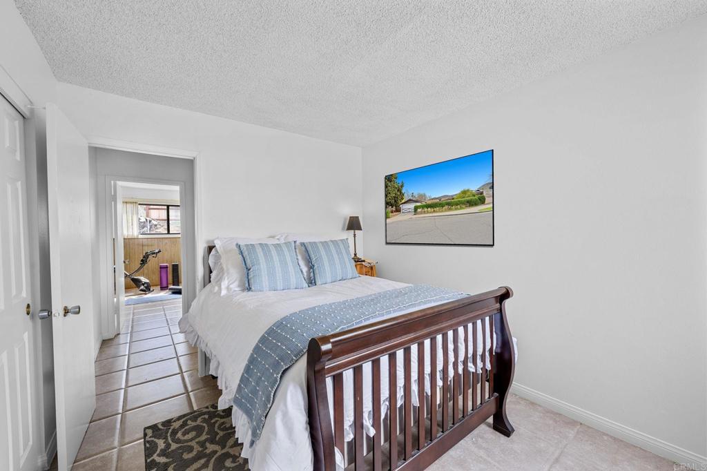 8109 Arlette Street Santee, CA 92071 - Photo 18 of 29 a bedroom with a bed and a painting on the wall