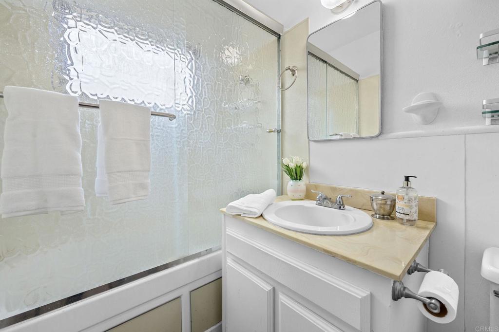 8109 Arlette Street Santee, CA 92071 - Photo 25 of 29 a bathroom with a granite countertop sink a mirror and shower