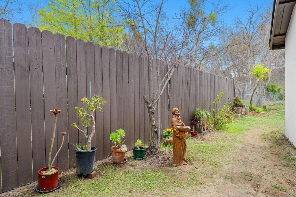 8109 Arlette Street Santee, CA 92071 - Photo 29 of 29 a backyard of a house with chairs and plants