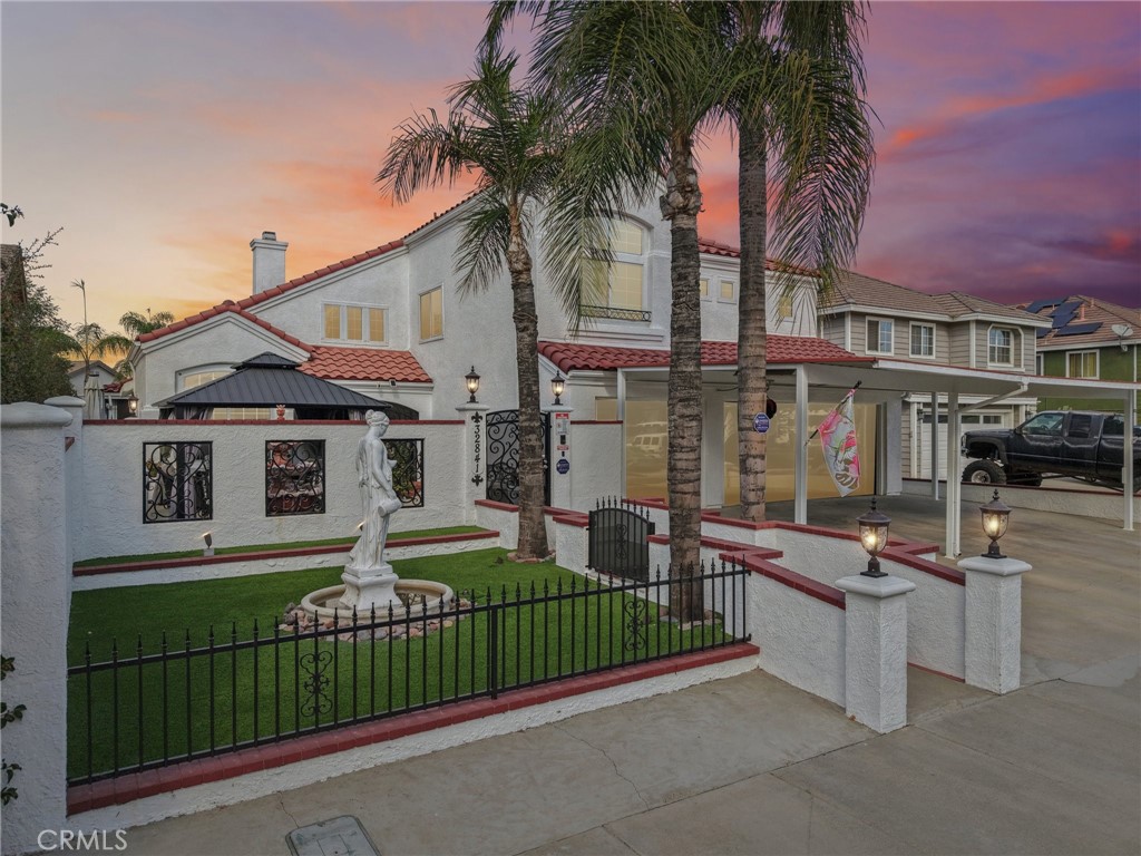 a front view of a house with a garden
