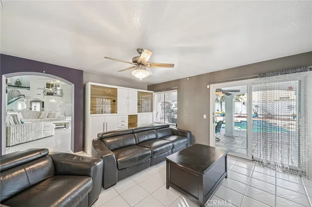 a living room with furniture and view of kitchen