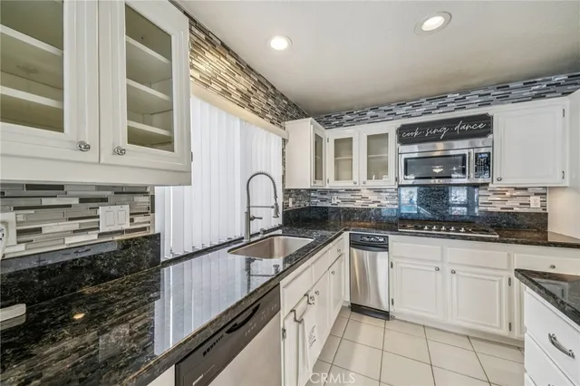 a kitchen with a sink cabinets and stainless steel appliances