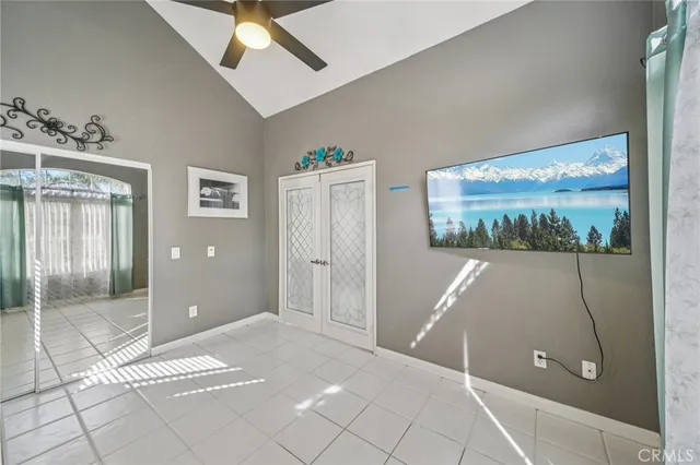 a living room with furniture a flat screen tv and kitchen view