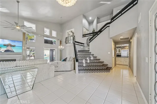 a living room with furniture and a chandelier