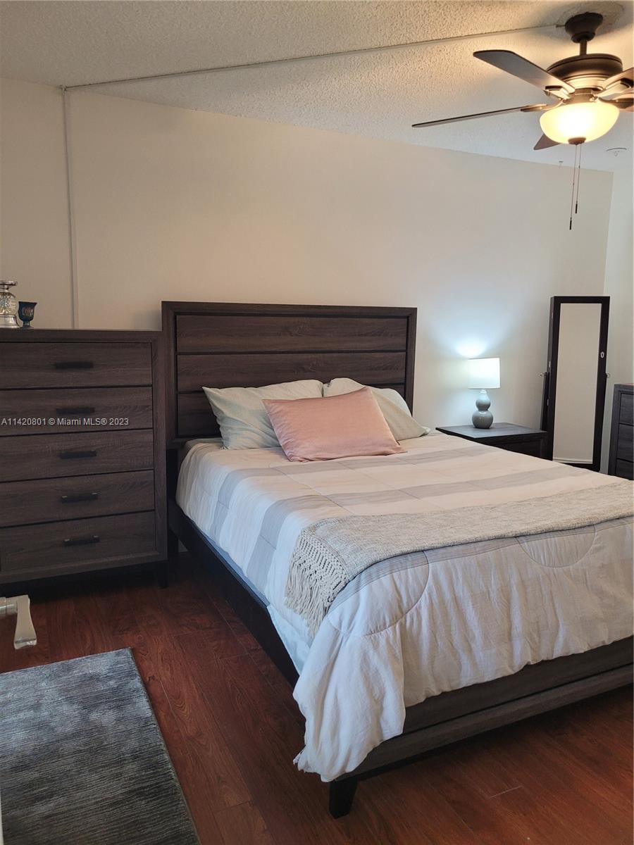 1066 North Hiatus Road, Unit 1066 Pembroke Pines, FL 33026 - Photo 11 of 33 a bedroom with a bed and a ceiling fan