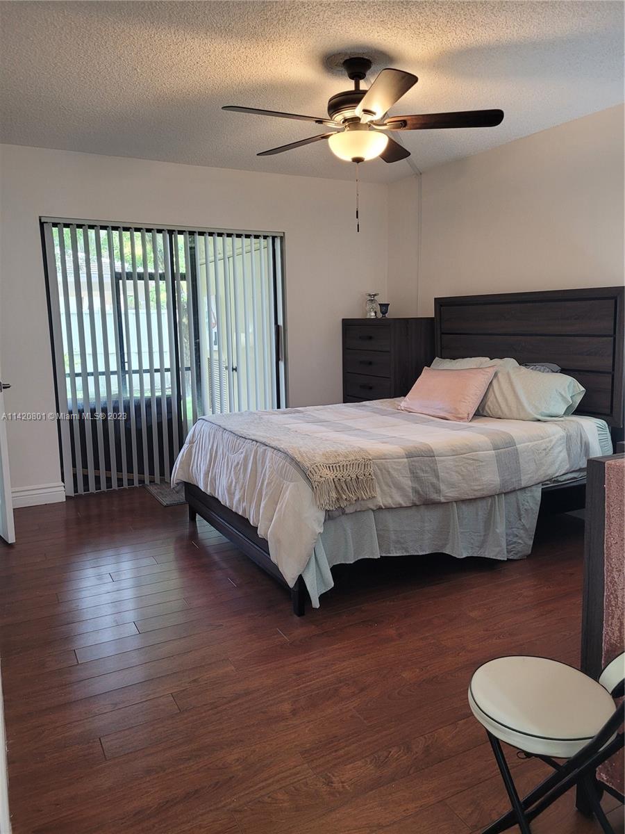 1066 North Hiatus Road, Unit 1066 Pembroke Pines, FL 33026 - Photo 12 of 33 a bedroom with a bed and a chandelier