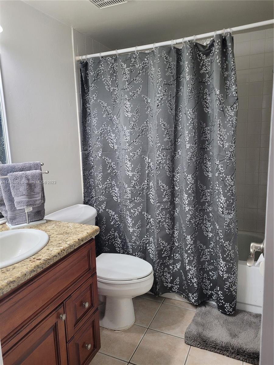 1066 North Hiatus Road, Unit 1066 Pembroke Pines, FL 33026 - Photo 22 of 33 a bathroom with a granite countertop toilet and a sink