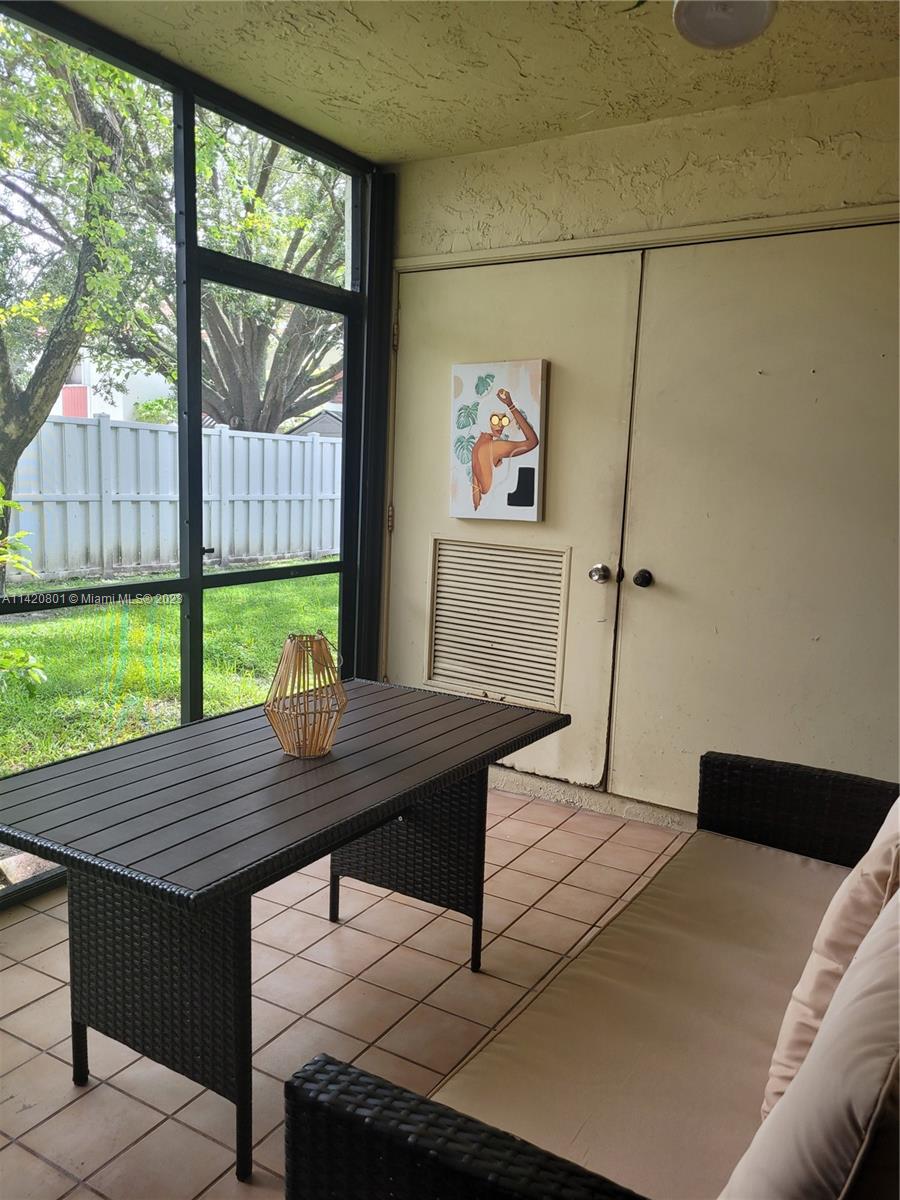 1066 North Hiatus Road, Unit 1066 Pembroke Pines, FL 33026 - Photo 24 of 33 a wooden floor with a table and chairs in it