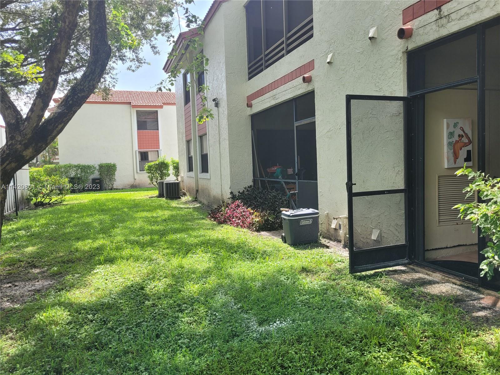 1066 North Hiatus Road, Unit 1066 Pembroke Pines, FL 33026 - Photo 28 of 33 a view of backyard with a garden and plants