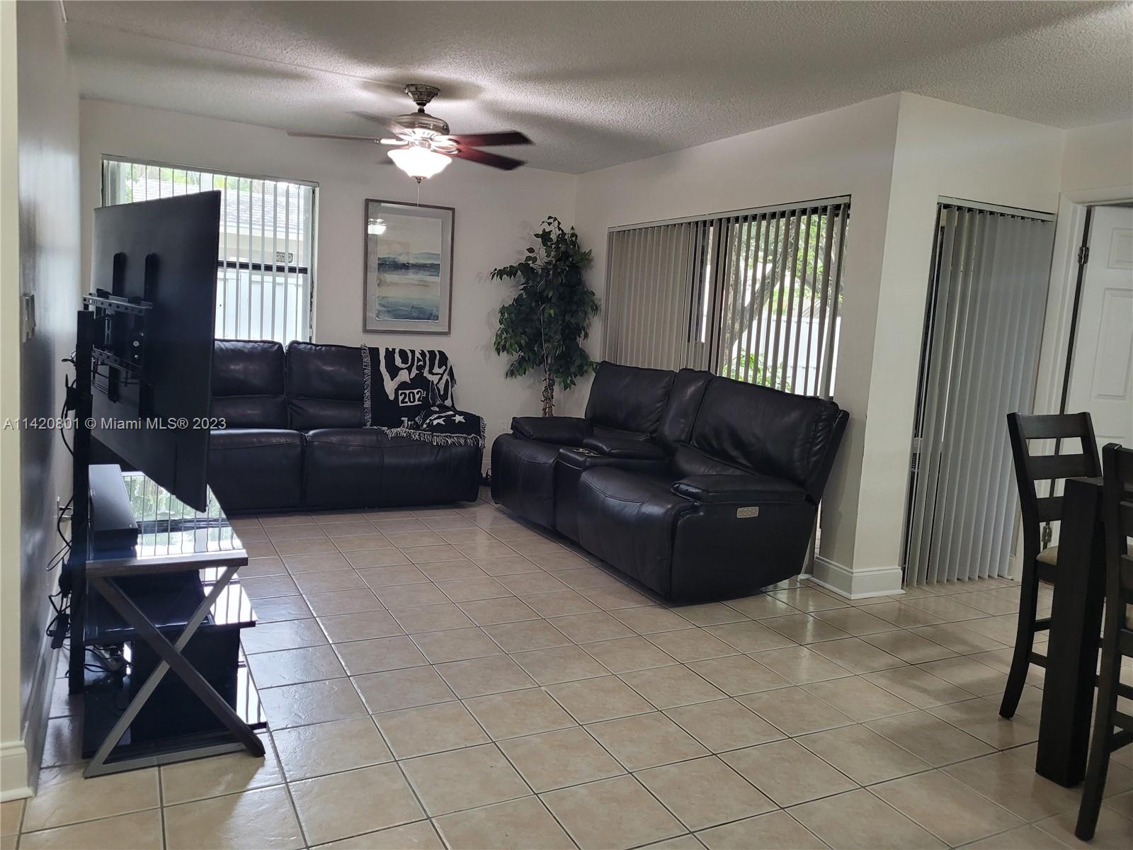 1066 North Hiatus Road, Unit 1066 Pembroke Pines, FL 33026 - Photo 3 of 33 a living room with furniture and a window