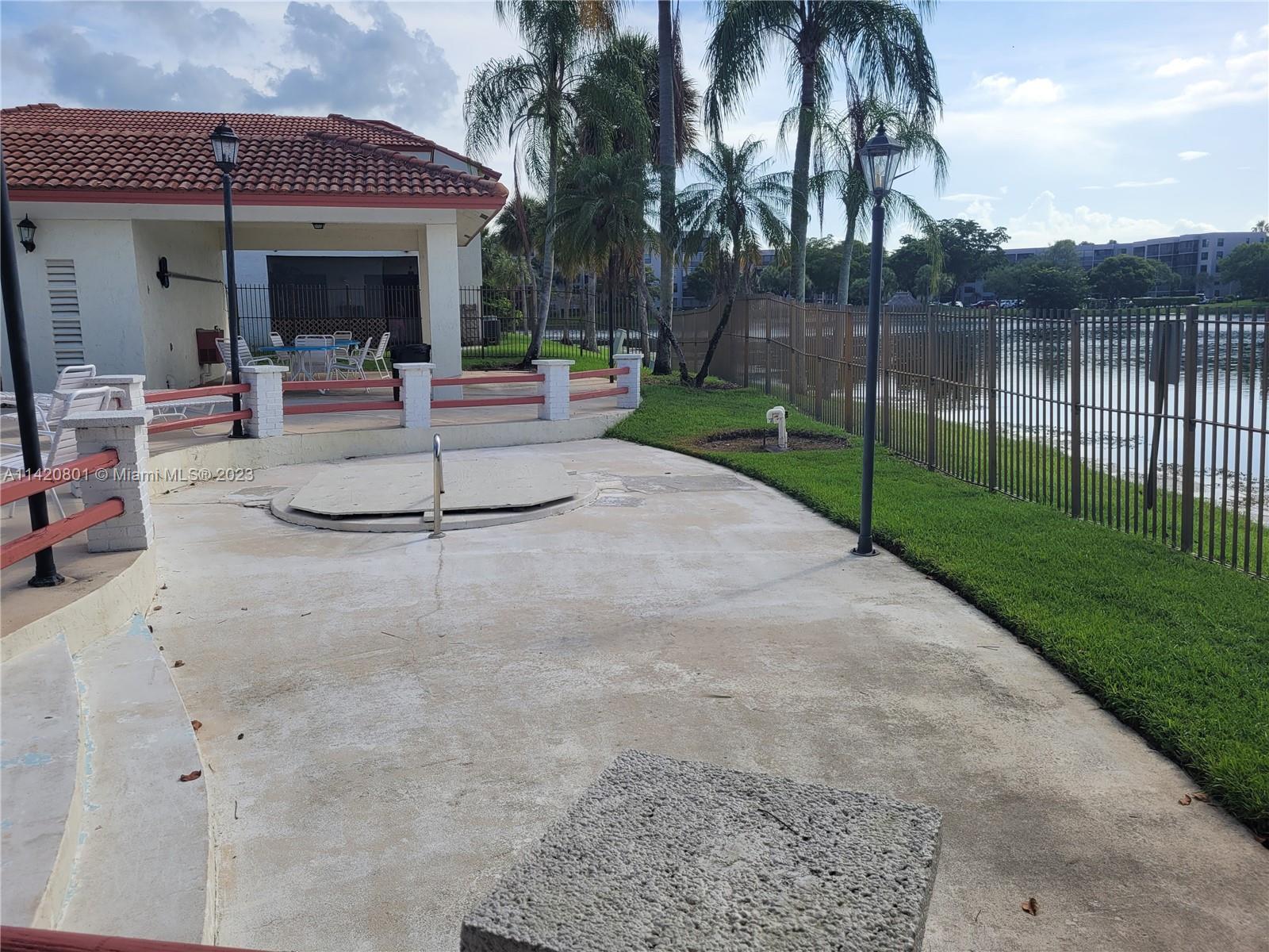 1066 North Hiatus Road, Unit 1066 Pembroke Pines, FL 33026 - Photo 31 of 33 a view of outdoor space yard deck and lake view