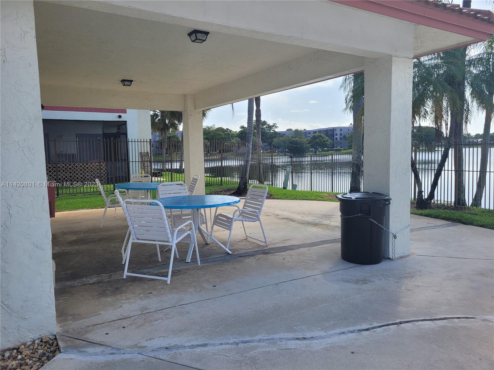1066 North Hiatus Road, Unit 1066 Pembroke Pines, FL 33026 - Photo 32 of 33 a view of a patio with a table and chairs