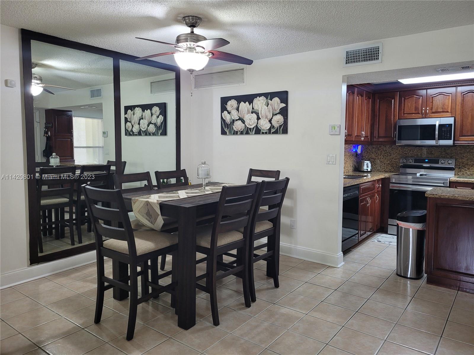 1066 North Hiatus Road, Unit 1066 Pembroke Pines, FL 33026 - Photo 5 of 33 a view of a dining room with furniture