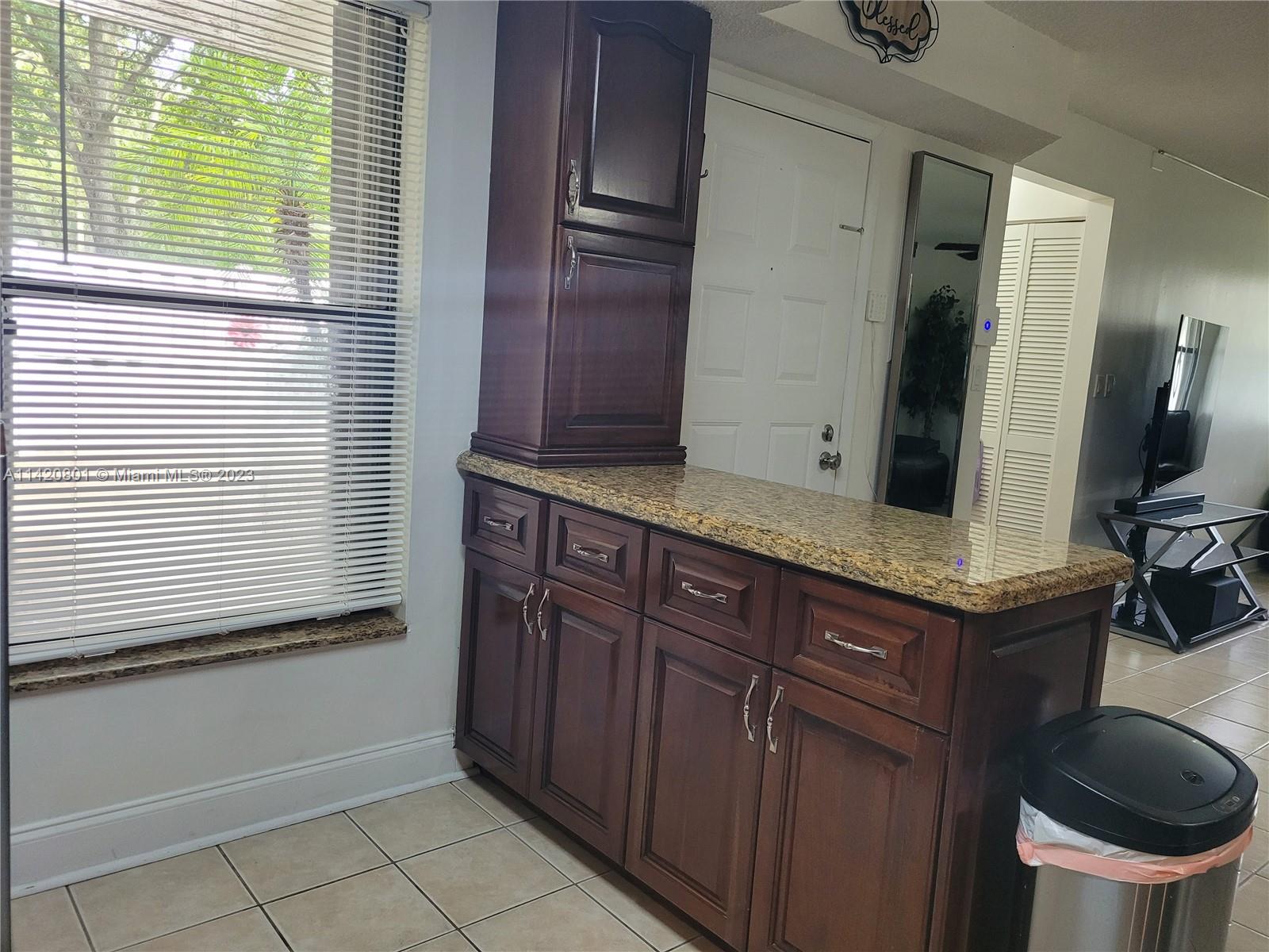 1066 North Hiatus Road, Unit 1066 Pembroke Pines, FL 33026 - Photo 6 of 33 a bathroom with a sink a toilet and a window