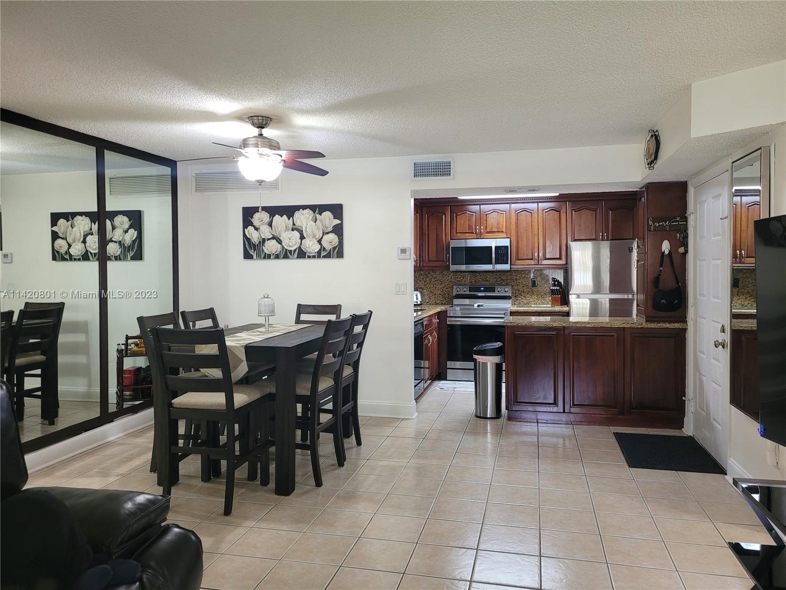 1066 North Hiatus Road, Unit 1066 Pembroke Pines, FL 33026 - Photo 9 of 33 a view of a dining room with furniture