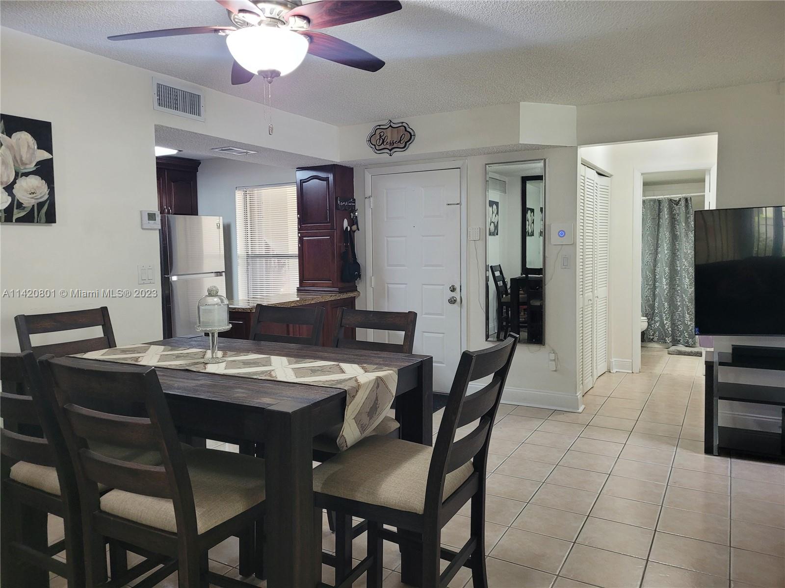 1066 North Hiatus Road, Unit 1066 Pembroke Pines, FL 33026 - Photo 10 of 33 a view of a dining room with furniture
