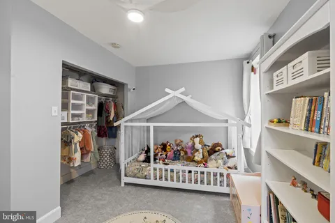a bedroom with furniture and a book shelf