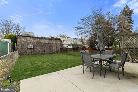 a view of a backyard with sitting area